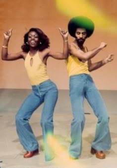 Couple dancing in 1970s outfits and flared jeans