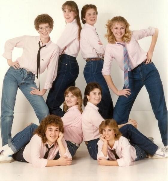Retro group photo of friends in pink shirts and matching jeans